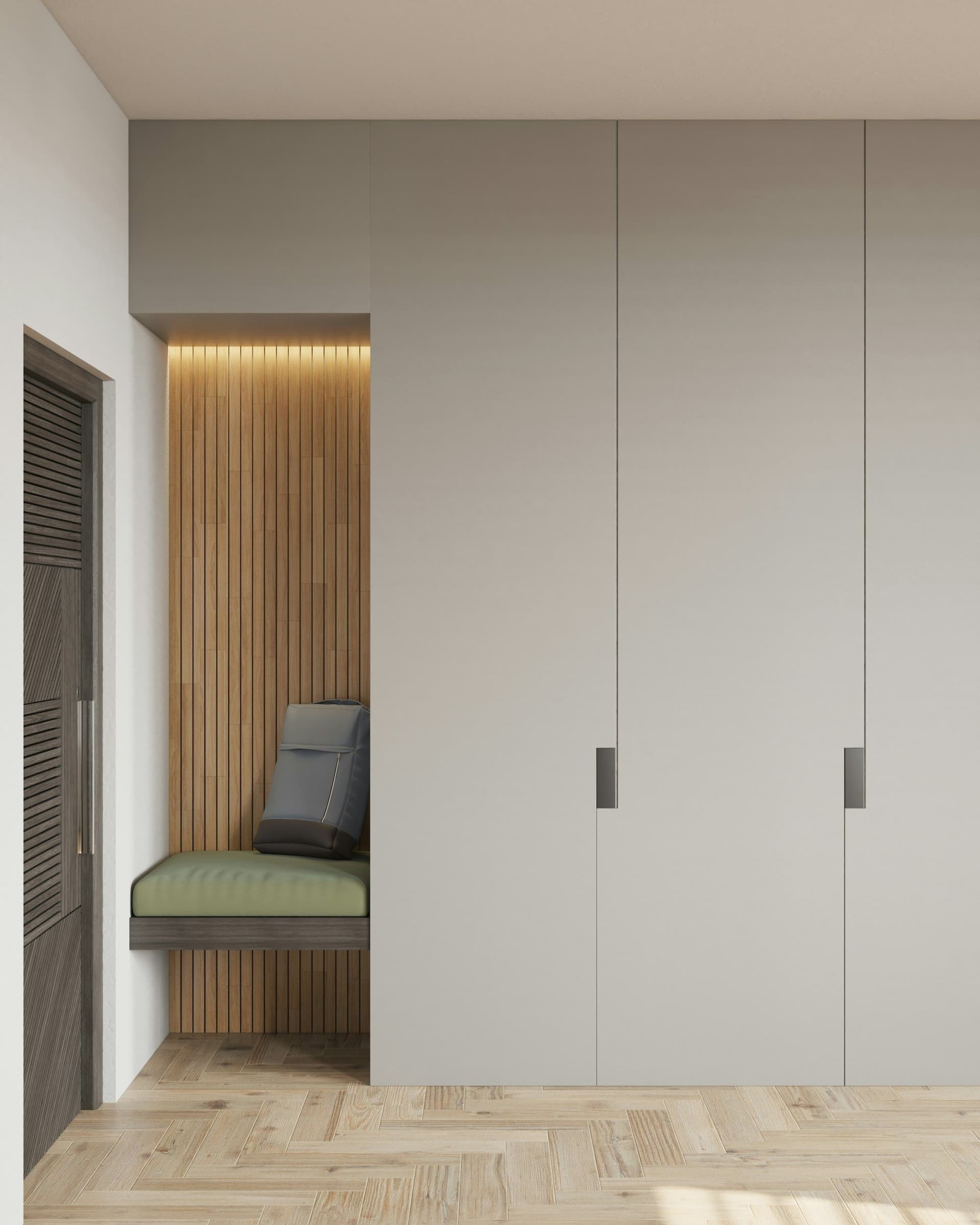 Full-height gray wardrobe doors beside a slatted wood niche with a built-in bench and herringbone floor
