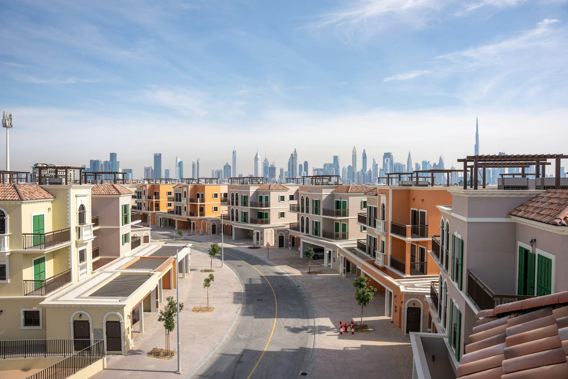 A row of new townhouses in Dubai with the city skyline behind